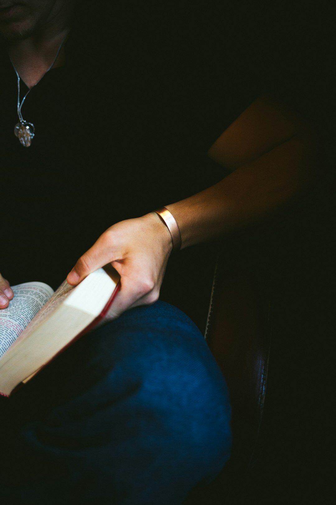 person reading mystery book at night